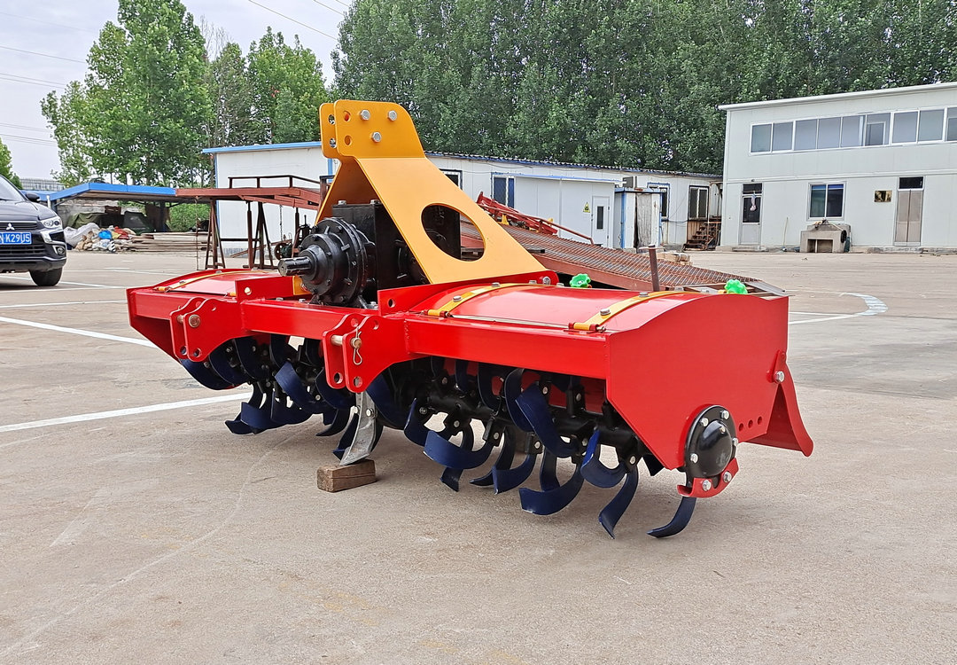 Four wheeled tractor with rotary tiller, agricultural land plowing and loosening machine, field breaking machine