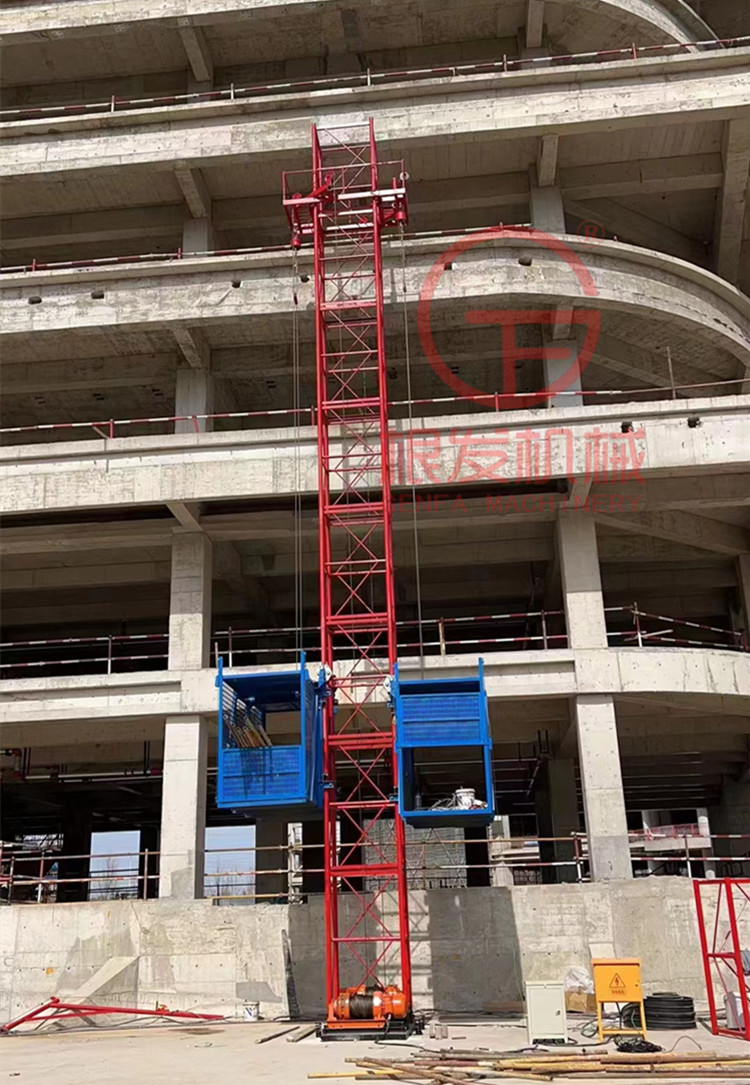 Fix one column and two cages with a construction material elevator on the construction site. Safety of construction elevators for preventing falling, single occupancy, and double cages