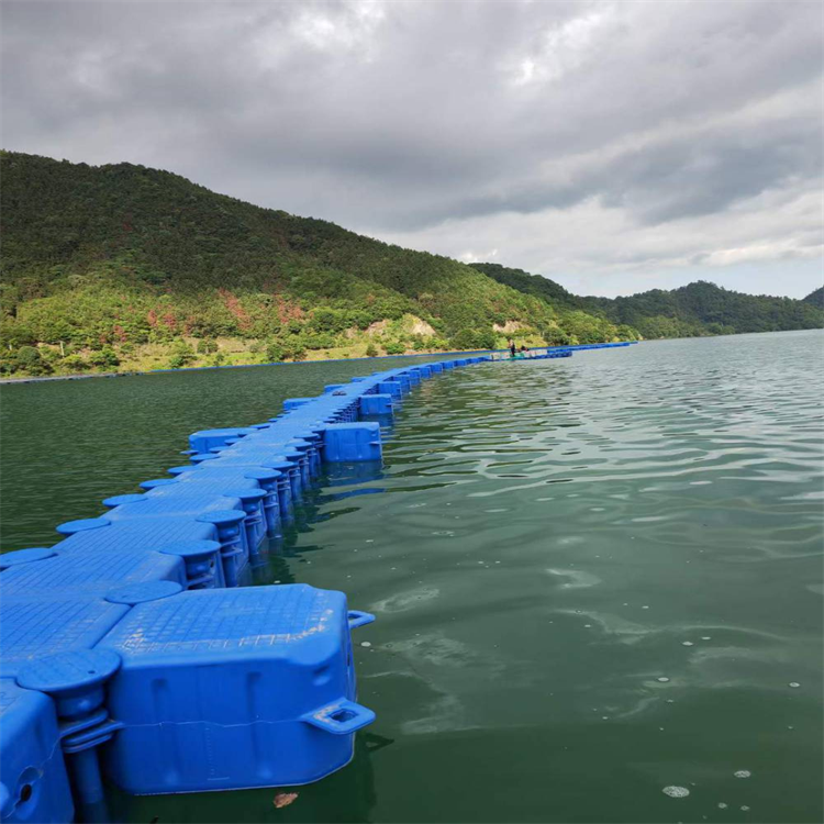 Aquatic aquaculture net cage yacht docks at a floating plastic movable dock on the sea